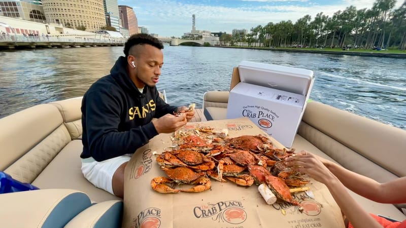 Steamed crabs on a boat with the waterfront behind