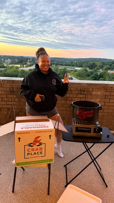 Customer unboxing crabs at a rooftop party