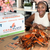 Smiling girl enjoying Steamed Maryland Blue Crabs for Birthday
