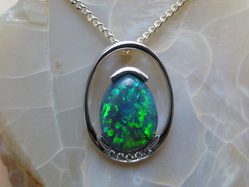 black opal and diamond pendant set in 14k white gold