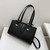 Strap-Closing Handbag