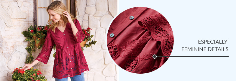 Image of a woman looking at some flowers outside wearing the red Trella Eyelet Top