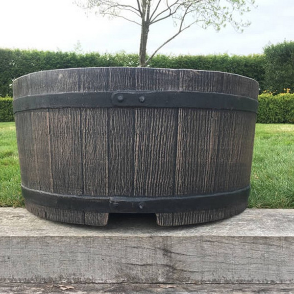 Mambo is a strong plastic garden planter, for use as an outdoor plant pot.  This half barrel garden planter is large capacity (28 litres of soil) to make it perfect for use for deep-rooted plants, shrubs, and small trees. Half barrel whiskey planter.