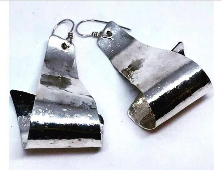 Sterling silver earrings that are also available in brass and patina (green).