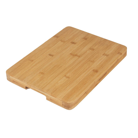 Rectangular bamboo chopping board with groove, shown from angled side view.