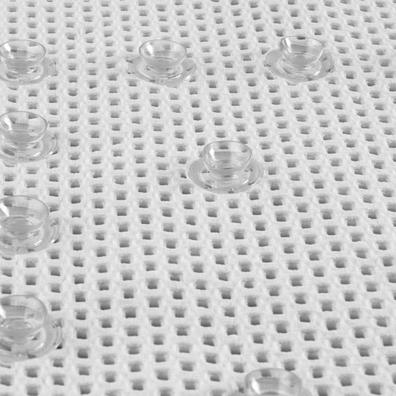 White anti-slip bath mat close-up showing clear suction cups