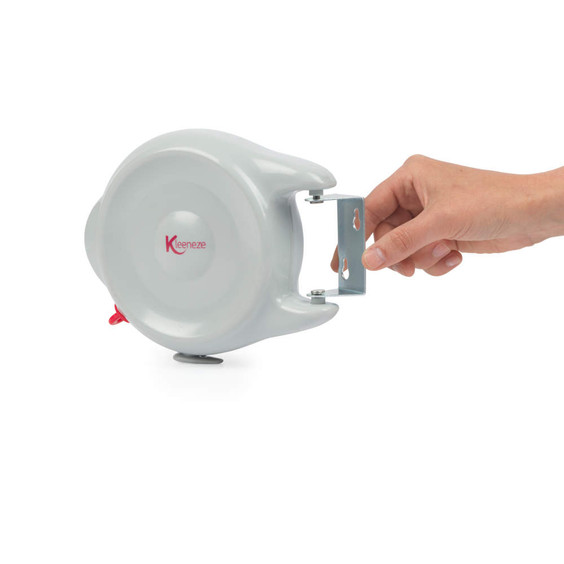 Retractable washing line in grey with wall bracket, held by a hand, side view