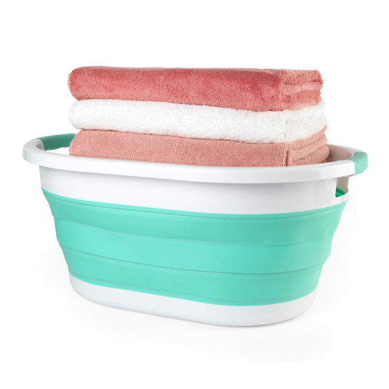 Collapsible teal laundry basket with three folded towels stacked on top
