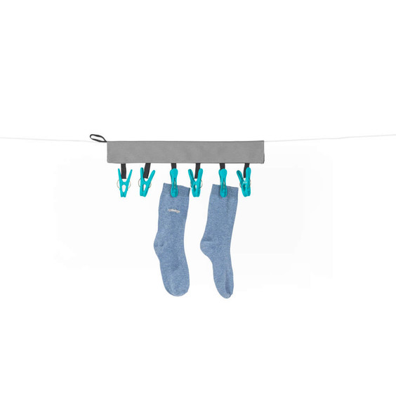 Grey peg strip holding two light blue socks with teal pegs on a washing line