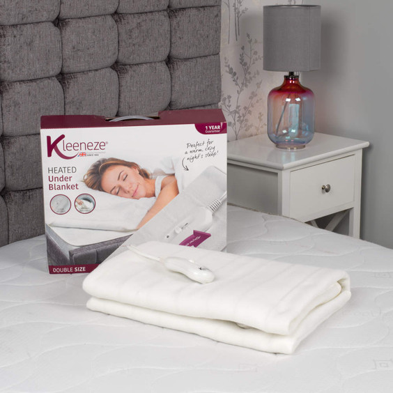Kleeneze heated under blanket, double size, shown with controller and packaging on bed.