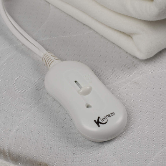 Kleeneze heated blanket controller showing slider on white mattress