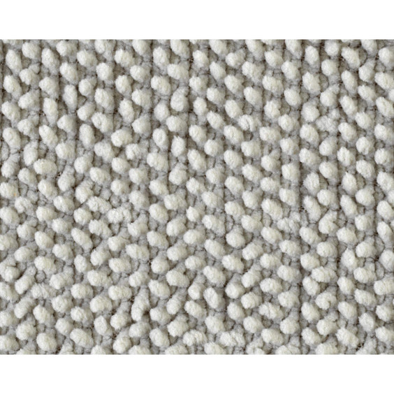 Light grey rectangular bath mat on bathroom floor next to white freestanding bath