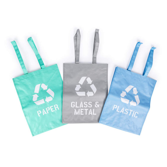 Set of three recycling bags for paper, glass & metal, and plastic in green, grey, and blue.