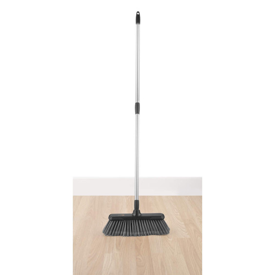 Hands gripping grey mop handle over kitchen sink, showing grip feature.
