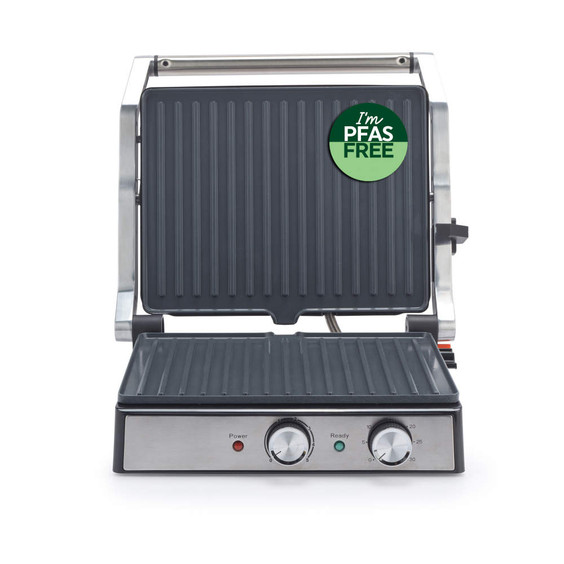 Open silver electric grill with PFAS free badge, showing control knobs and grill plates