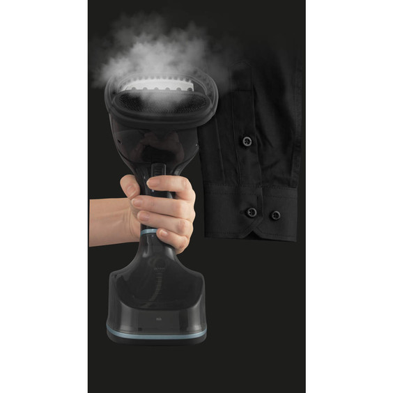 Handheld garment steamer in use with steam on black shirt cuff