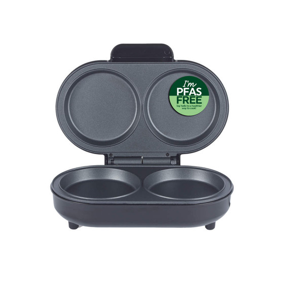 Double egg cooker with PFAS free label, shown open with two round cooking wells.