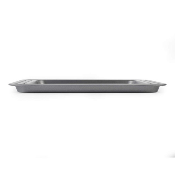 Silver non-stick baking tray, oblique side view, shown on white background