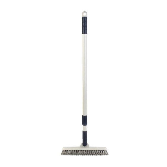Grey handled floor scrub brush with stiff bristles for cleaning, shown upright.