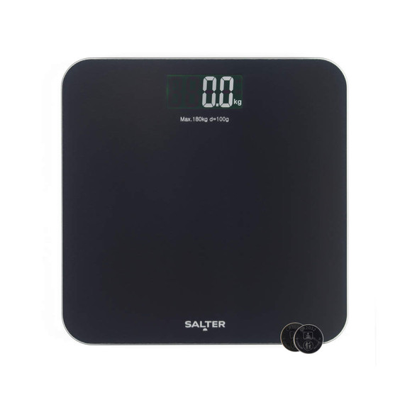 Black digital bathroom scale with large display, shown with batteries included.