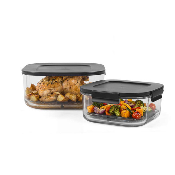 Set of two glass food storage containers with black lids, shown with roast chicken and vegetables
