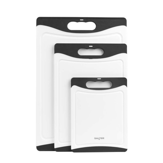 Set of three white and black plastic chopping boards with handles, shown stacked.