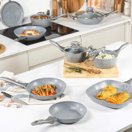 Grey non-stick cookware set on kitchen counter, includes frying pans, saucepans and lids