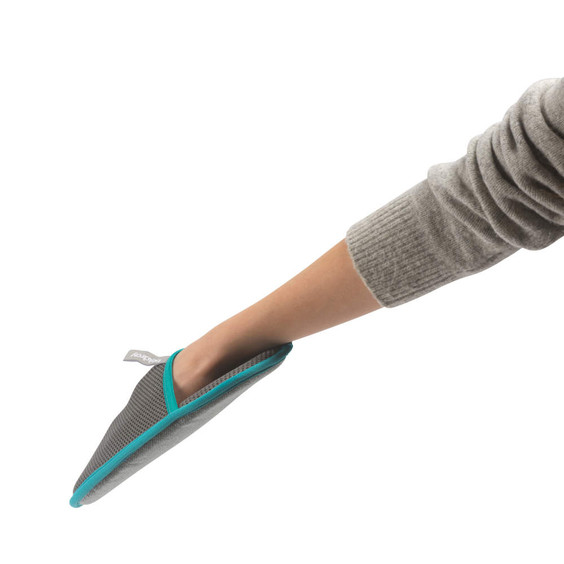 Grey and turquoise pet mitt worn on hand, side view, shown for use.