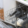 Open dishwasher rack with mugs and wine glasses inside