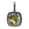 Grey square grill pan with salmon, spinach, tomatoes, broccoli, and lemon slices