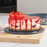 Strawberry cheesecake with biscuit base and strawberry topping on serving plate