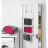 White over door towel rail with three hanging bars, shown holding grey and pink towels.