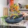 Non-stick frying pan tossing mixed peppers in modern kitchen