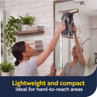Person using handheld window vacuum on bathroom mirror; lightweight and compact for hard-to-reach areas.