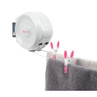 Wall-mounted retractable clothes line with pink pegs and hanging grey towel