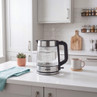 Glass electric kettle with stainless steel base on kitchen counter