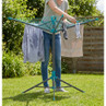 Outdoor rotary clothes airer with laundry hanging, shown in garden setting