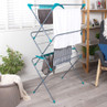 Large folding clothes airer with assorted laundry hanging, shown in a bright living space