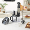 Black and silver food processor with accessories on kitchen countertop