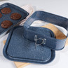 Blue speckled non-stick rectangular baking tin set on worktop, with cookies in tray.