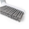 Grey cleaning brush head with stiff bristles, shown close-up on white background