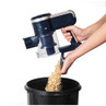 Hand emptying cordless vacuum cleaner dust container into a bin