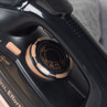 Close-up of black and rose gold steam iron temperature dial, showing settings