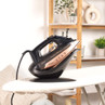 Beldray cordless black and copper steam iron on charging base, shown on ironing board