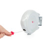 Wall-mounted retractable washing line with pink pull handle, shown extended
