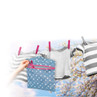 Blue star print wet bag with pink zip held in front of baby clothes on washing line