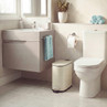Modern grey bathroom vanity unit with sink beside toilet