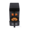 Black dual drawer air fryer with cooked chicken and chips inside, front view