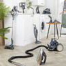 Assorted grey and silver home cleaning appliances displayed in a laundry room