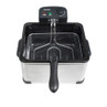 Silver deep fat fryer with black handle and control dial, shown empty from above